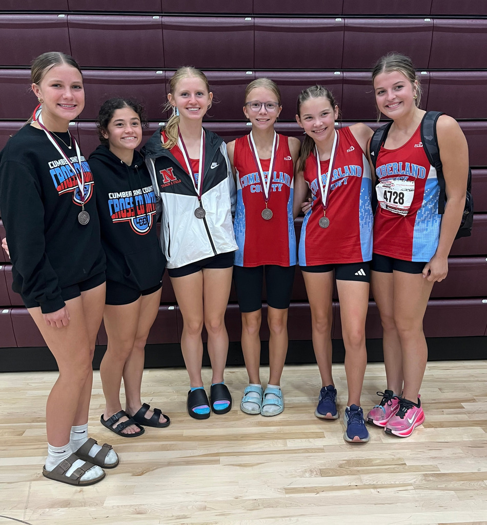 Pictured are six of the runners. Five are medalists wearing thir medals.