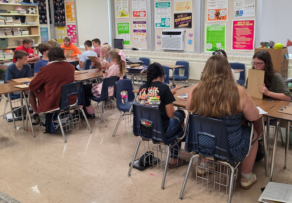 Students are sittign in groups of 4-5 playing the game.
