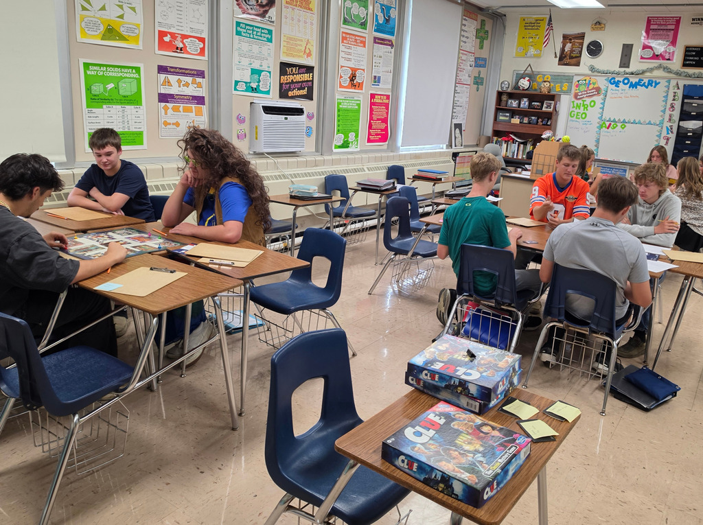 Students are sittign in groups of 4-5 playing the game.