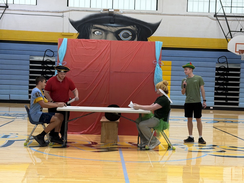 Five students are doing a skit. One is Tinkerbell, one is Peter Pan, one is Captain Hook, and the fouth is a Cumberland football player.