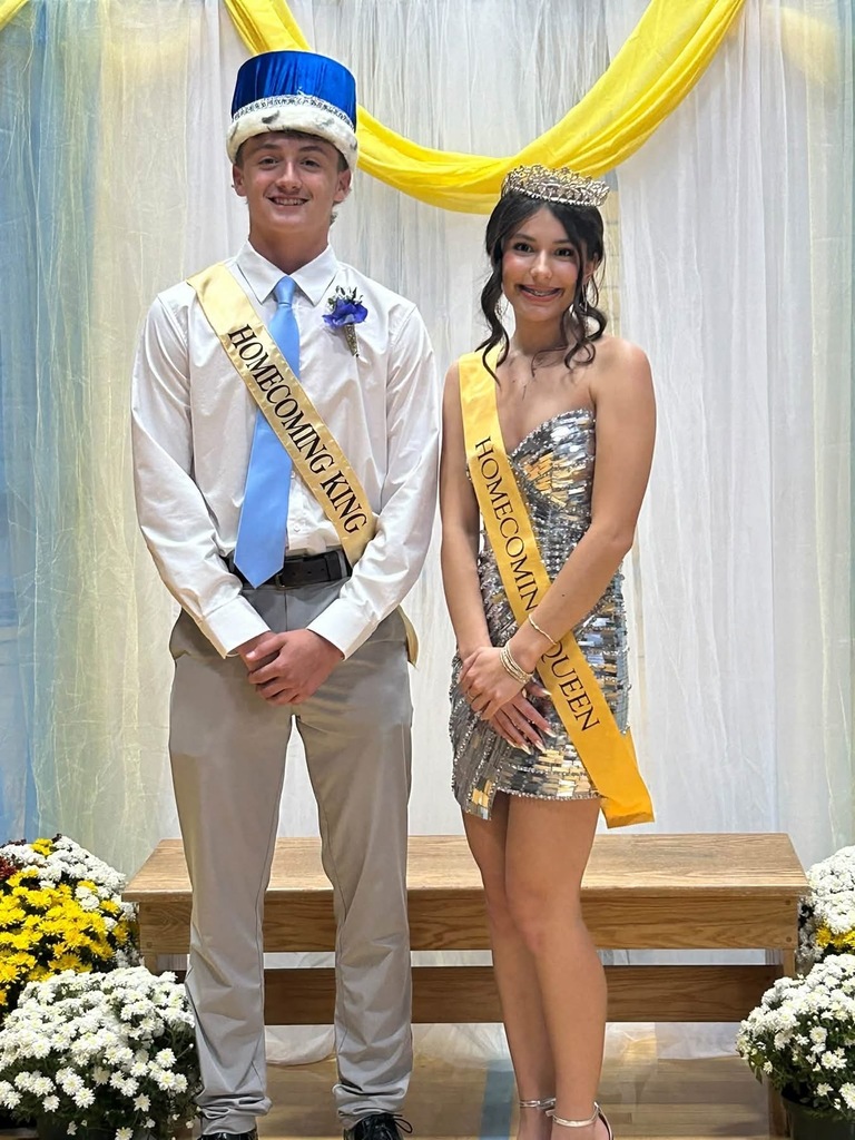 Pictured are the king and queen wearing crowns cand sashes. 