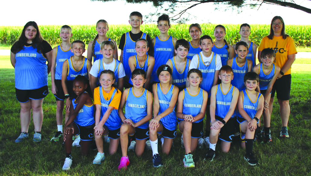 Pictured is the team in uniform in three rows. The coach is to the right side.