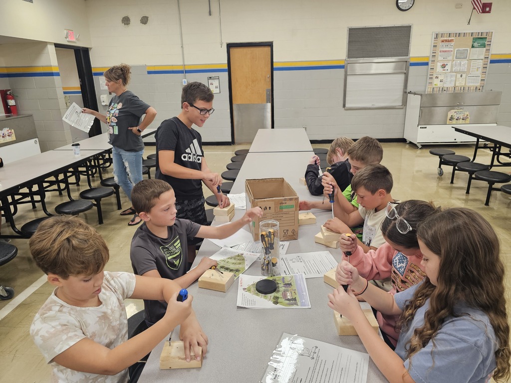 Students are using a screw and a screwdriver to learn about the simple machine. 