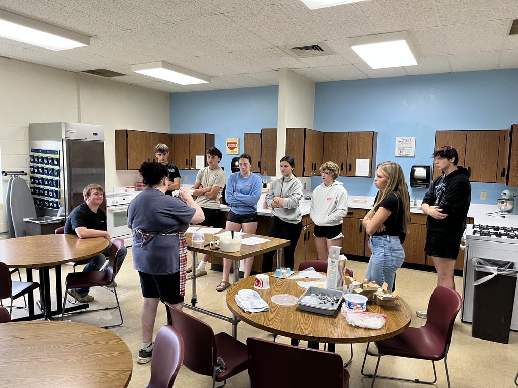 Patty is facing the students and showing some techniques.