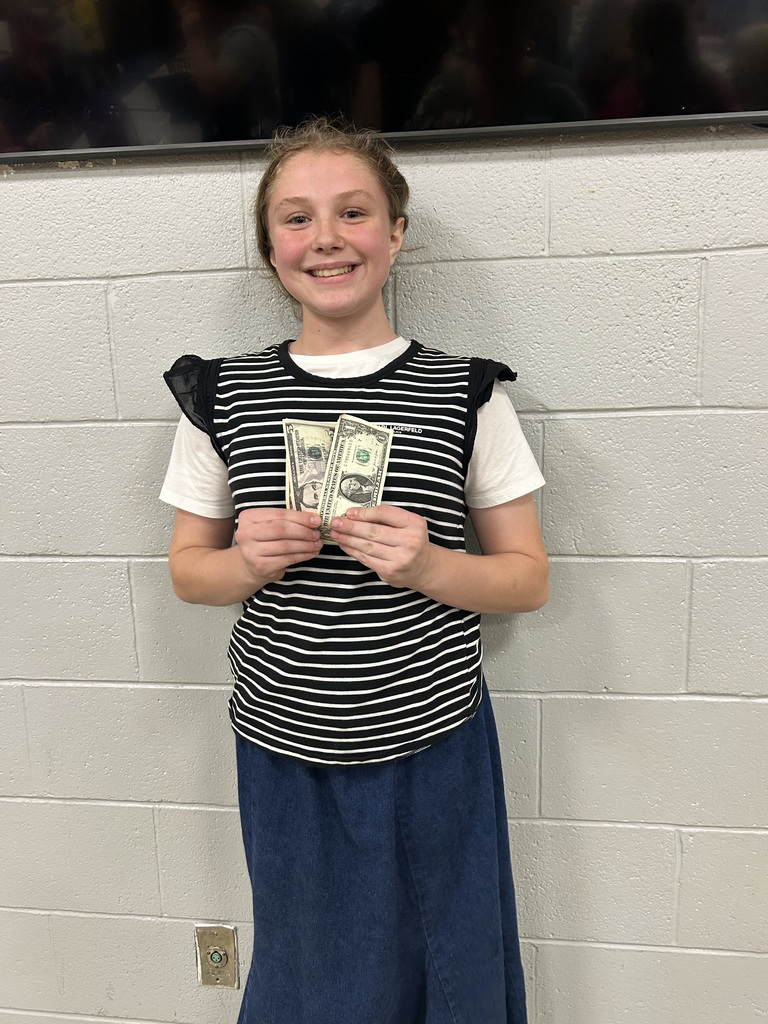 One student is holidng the cash won for filling the card for bingo.
