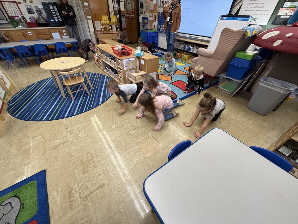 Students are crawling on the floor. 