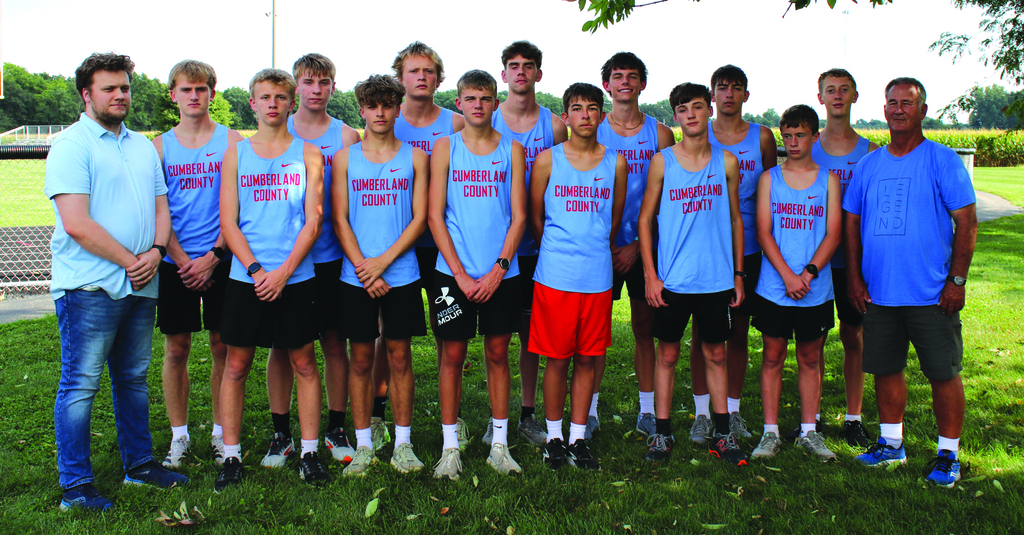 Pictured is one of the teams in uniform flanked by their coaches. 