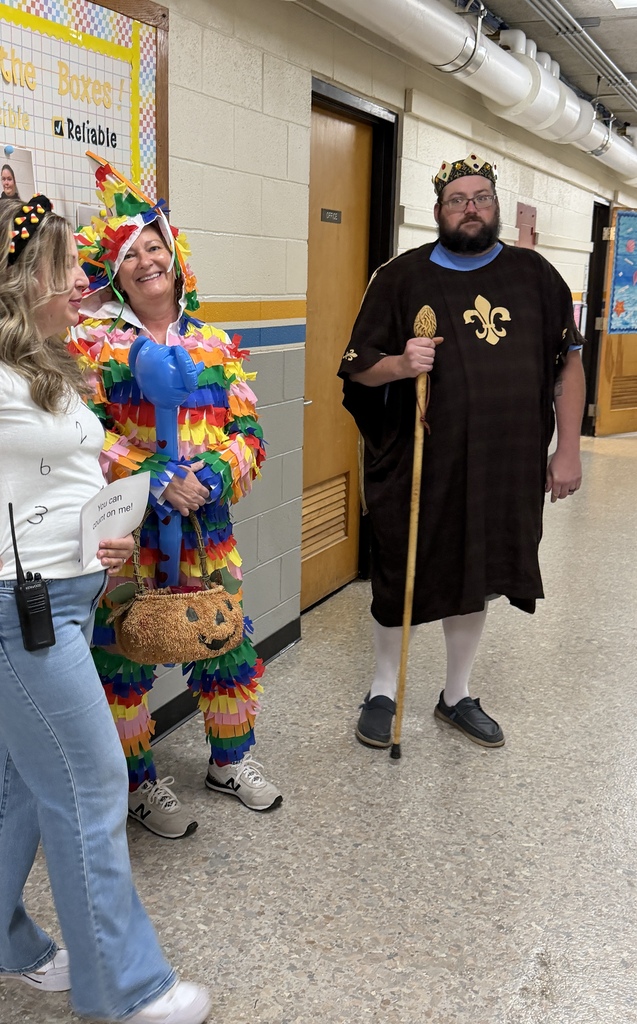 Three staff members are dressed up. One is a pinata, another a king, and a third is a number.