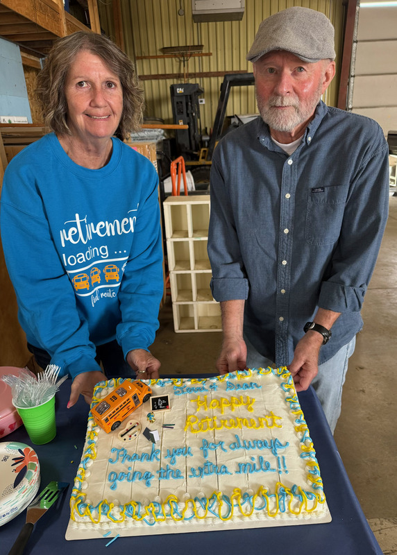 Pictured are the two bus drivers holding up their retirement cake.