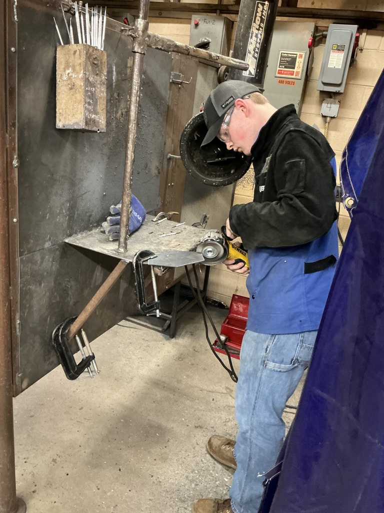 Welding students grind