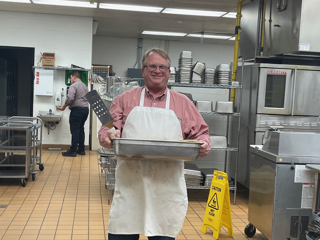 Mr. Wolfe Admin Director Serving up trays for breakfast