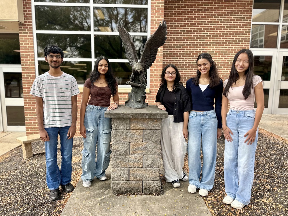 Five CVHS students stand in front of an Eagle statue.