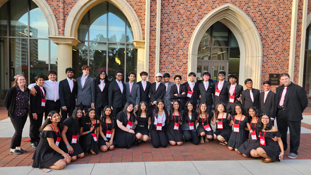 CV High School and Eagle View Science Olympiad teams pose together outside a brick building at the 2026 National Tournament at USC.