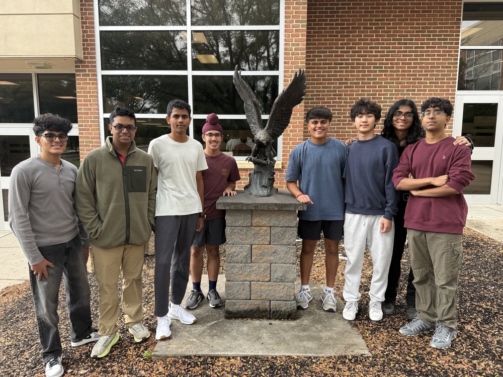 Eight Cumberland Valley High School student pose next to an Eagle statue as they were selected as National Merit Scholarship Semifinalists.