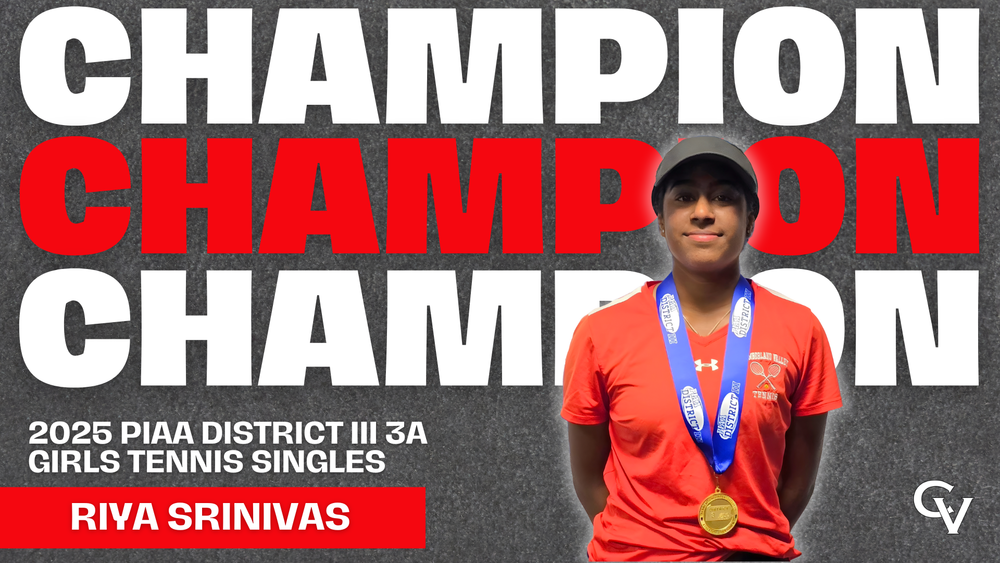 Female tennis player in a red shirt with a blue medal standing in front of a “CHAMPION” backdrop, labeled “2025 PIAA District III 3A Girls Tennis Singles – Riya Srinivas.”