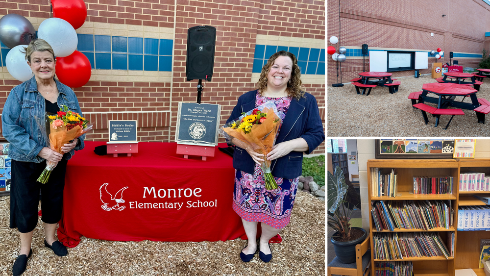 Two people with bouquets stand beside a plaque table during a dedication ceremony at Monroe Elementary School.
