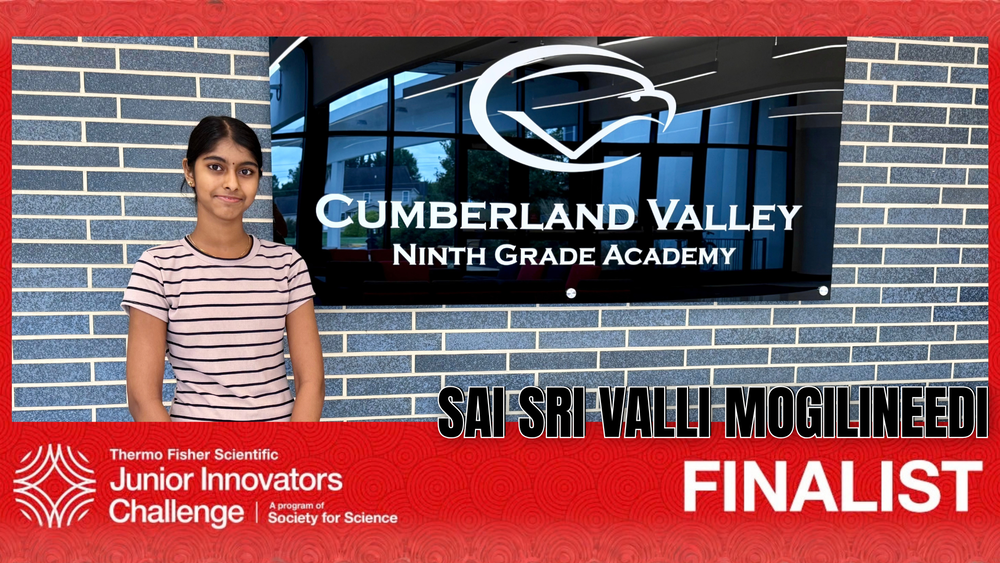 CV9 student Sai Sri Valli Mogilineedi standing beside a Cumberland Valley Ninth Grade Academy sign, recognized as a Thermo Fisher Scientific Junior Innovators Challenge finalist.