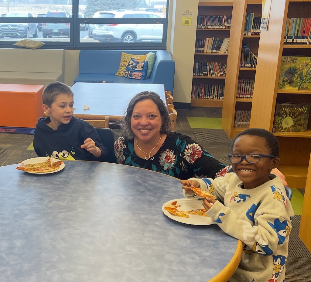 Monroe Elementary students enjoy a pizza party with Ms. Lavoie.