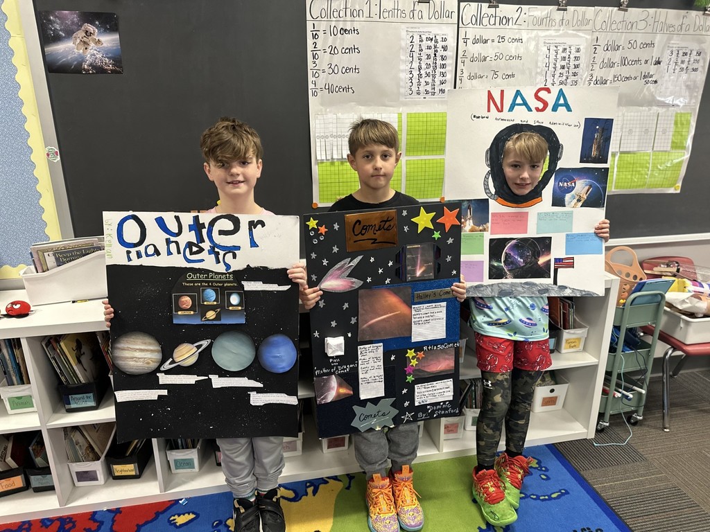 Third-grade students at Silver Spring Elementary show off their space projects.
