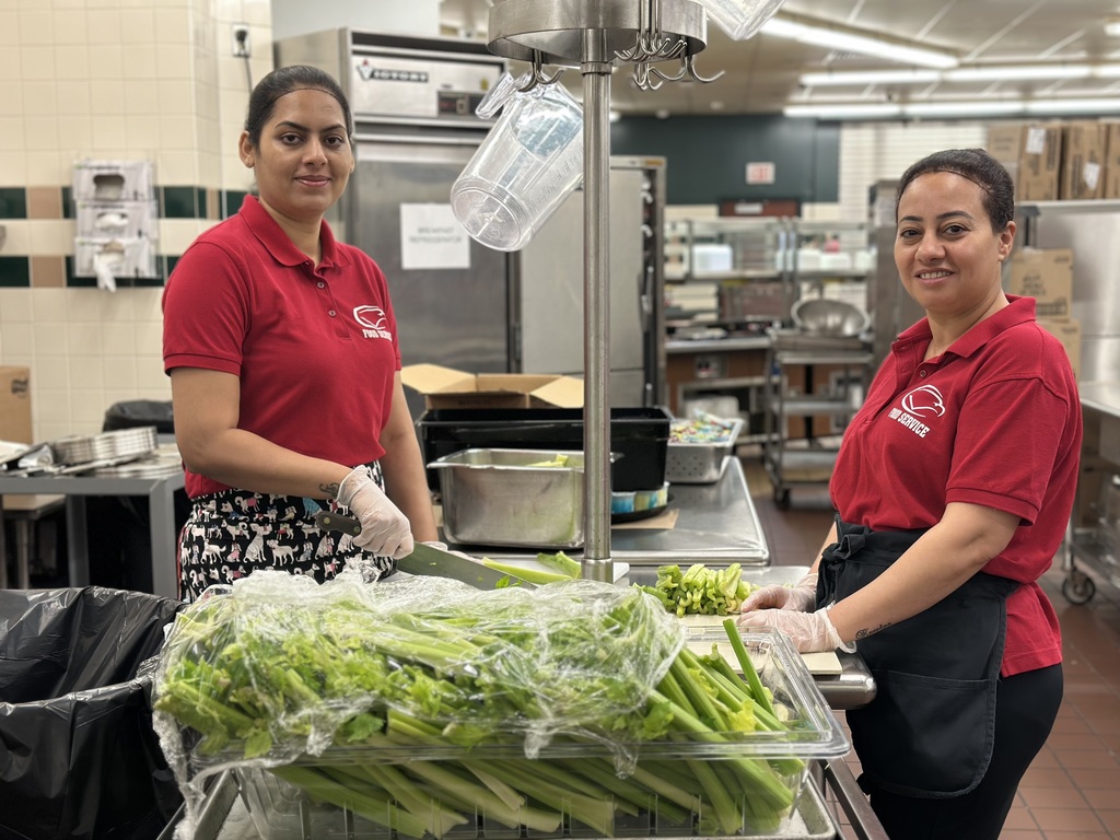 Two kitchen staff preparing celery for lunch in the CVHS kitchen.