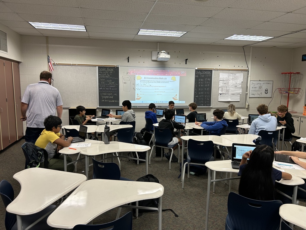 Mr. Kincer helping class of students.