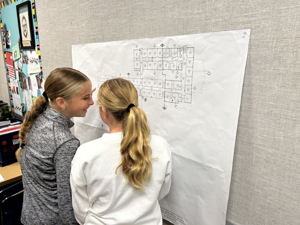 Two students happily working