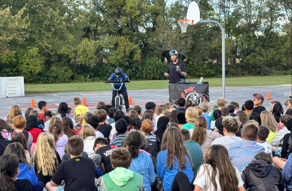 Monroe Elementary students listening to BMX stuntmen speak.