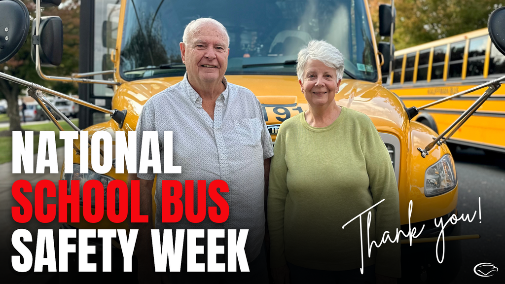 Ron and Maria Reedy who drive for Kauffman Bus, stand in front of a yellow school bus with text highlighting National School Bus Safety Week.