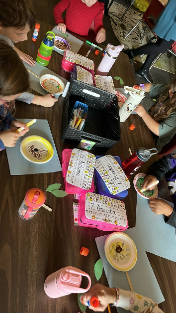 Students at a table creating plant diagrams