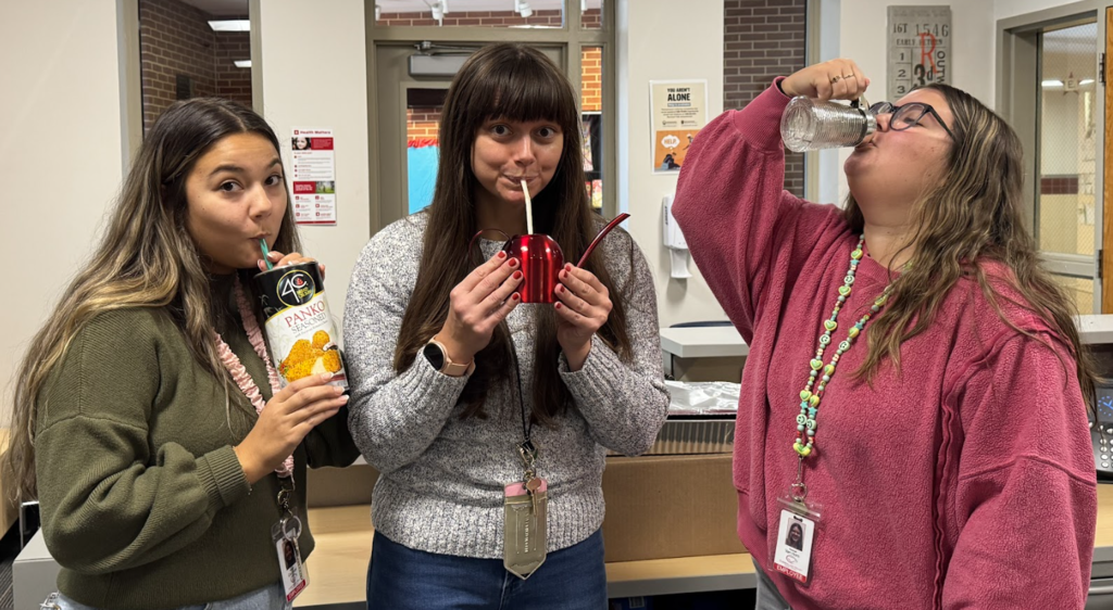 Three teachers drinking from their "Anything but a Cup" choices; panko container, watering can, and syrup bottle.