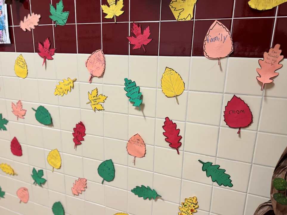 Paper leaves listing what children are thankful for.... one says "family"