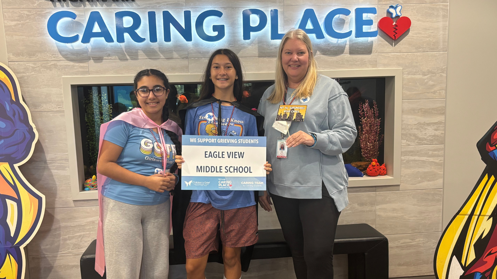 Two Eagle View Middle School students standing together indoors, holding materials related to Children’s Grief Awareness Day.