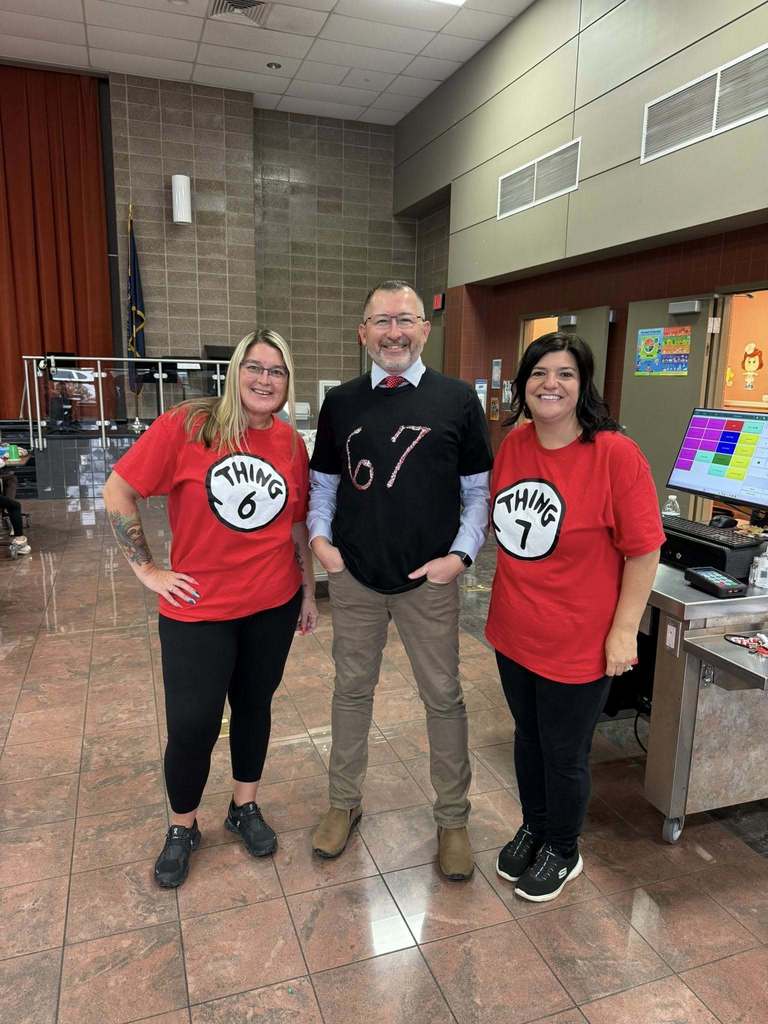 Three teachers wearing themed shirts—two in red labeled “Thing 6” and “Thing 7,” and one in black with “67”—celebrating the 67th day of school.