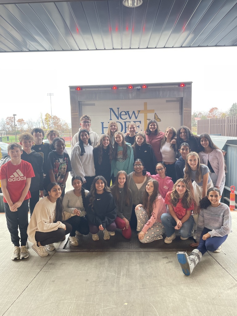 Group of Mountain View Middle School students posing in front of a New Hope Ministries truck during the school’s canned food drive.