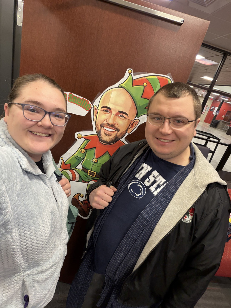 Mountain View Middle School staff take a selfie with the festive paper elf Snelfie in the front office.