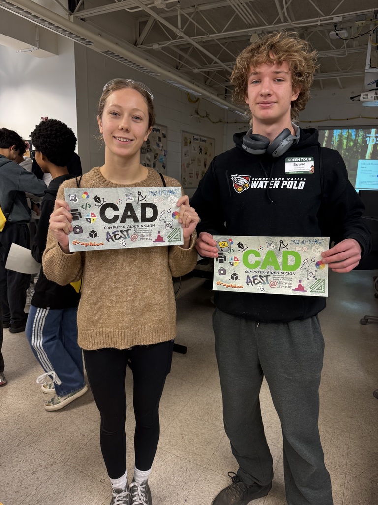 Two CVHS students hold colorful CAD-themed signs during AEST Exploration Day at Millersville University.