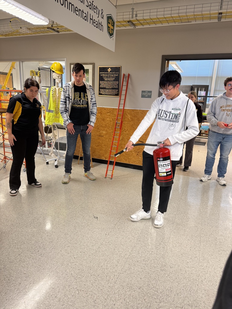 CVHS students participate in a safety activity at Millersville University, practicing with a fire extinguisher during AEST Exploration Day.