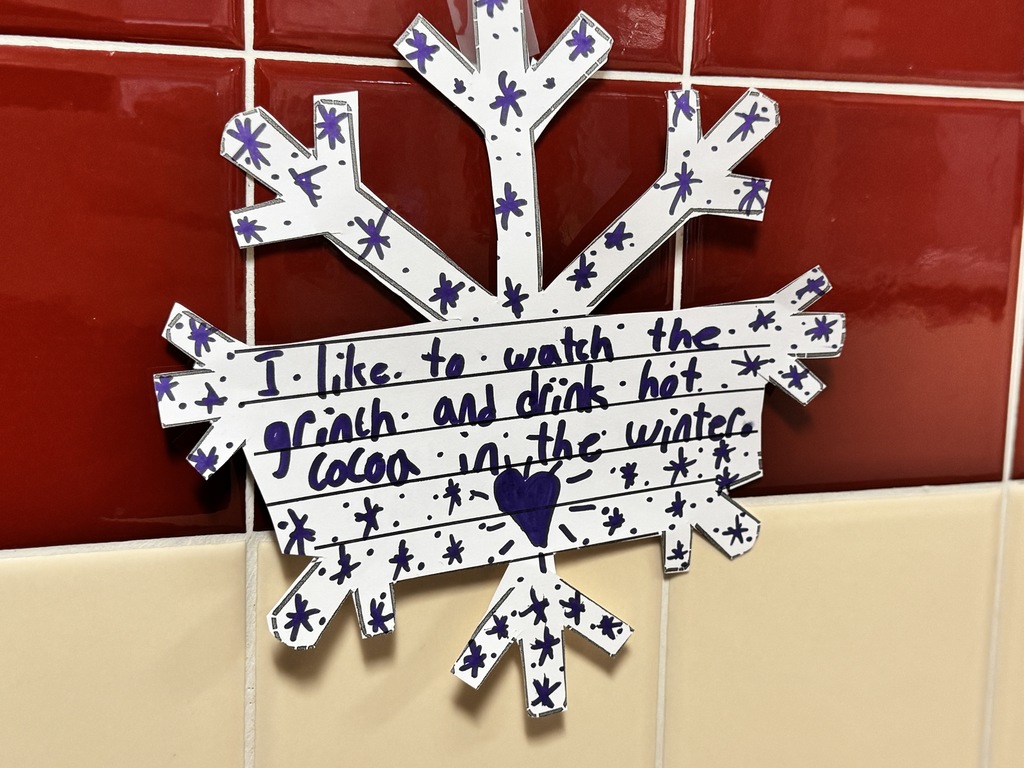 White snowflake with drawn stars and a heart in the center.