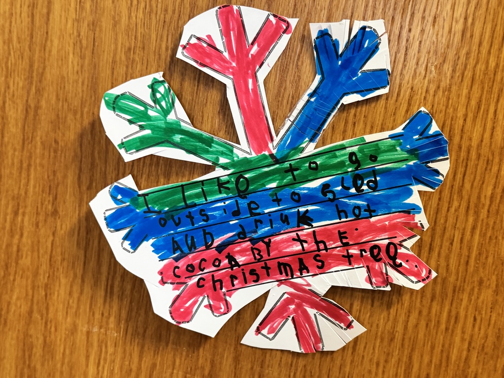 Red, green, and blue snowflake with student writing.