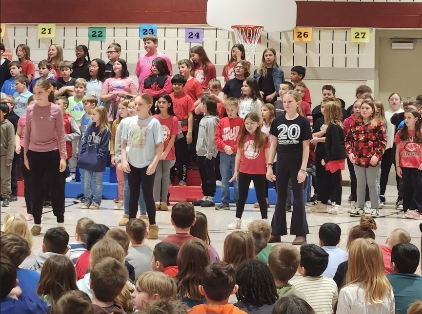 Students standing and sitting during concert