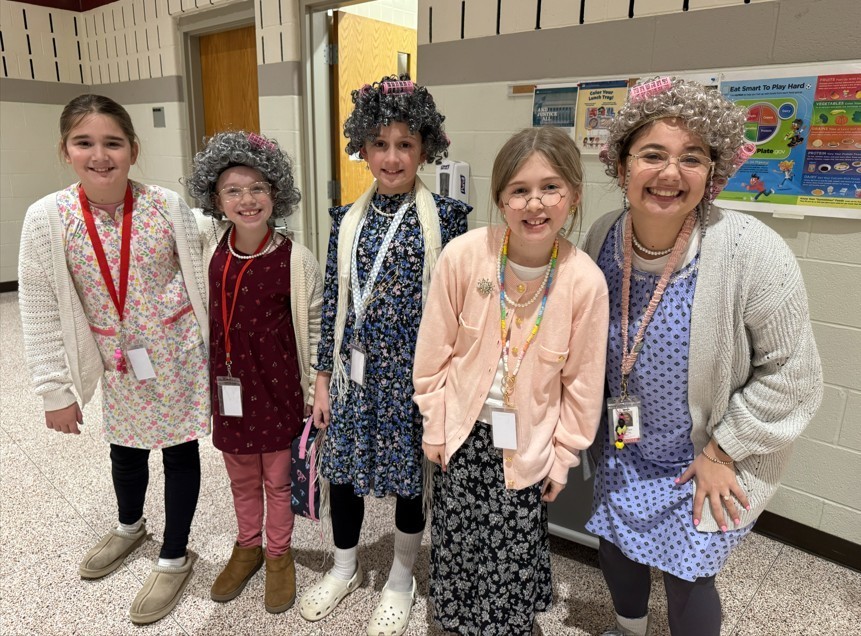 Female teacher with four female students dressed as 100-year old ladies for our 100th  day of school.