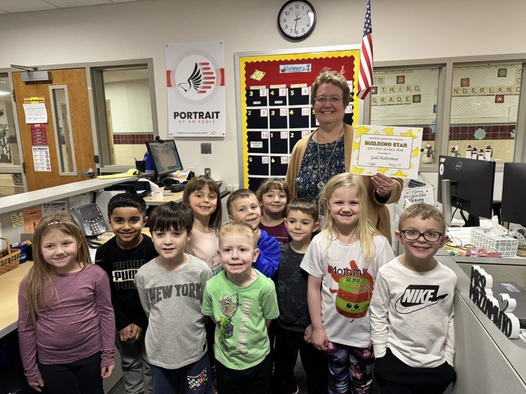 Woman holding certificate, standing with children.