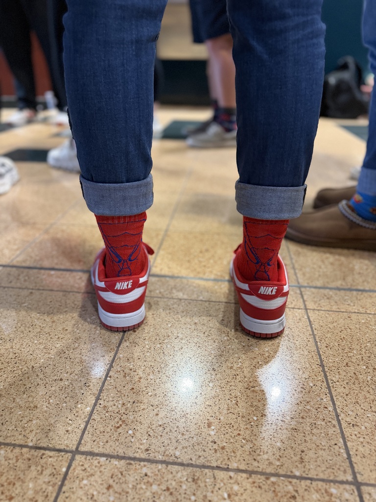 A picture of a staff showing off their spider man socks for World Down Syndrome Day.