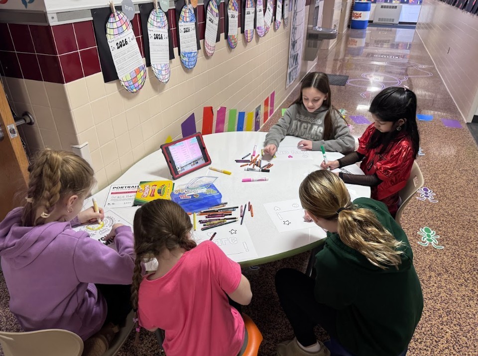 Five girls working on encouraging pictures