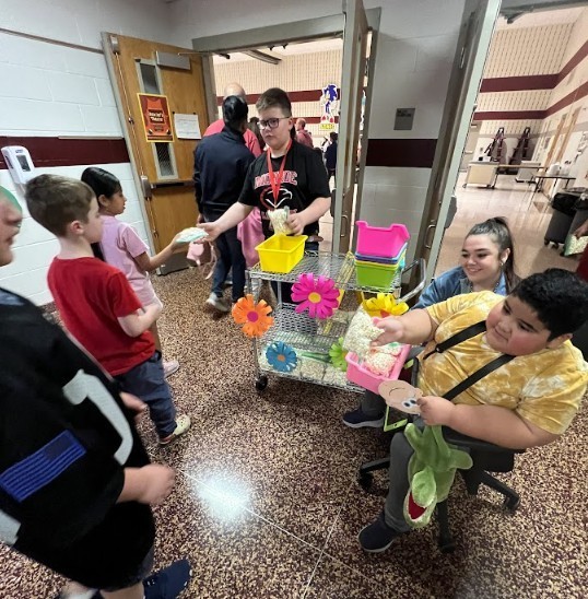 Students handing out popcorn to other students