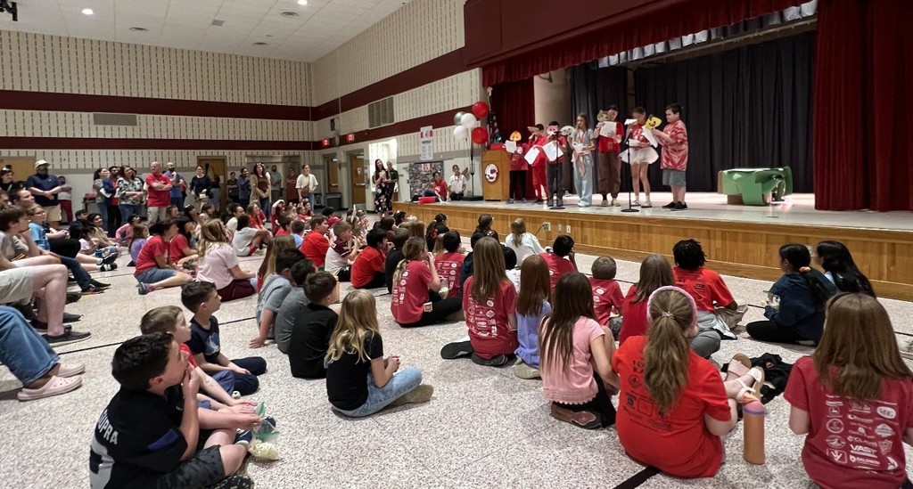 Students and families watch students on stage.
