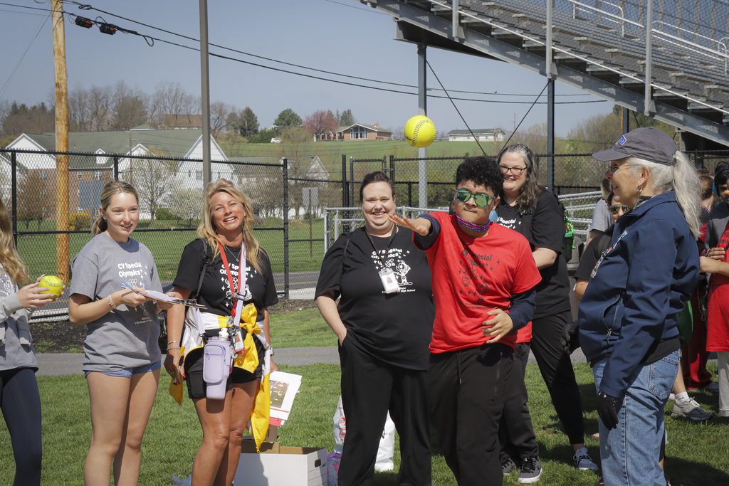 A student in a red shirt launches a softball during the shot-put event at CV's Special Olympics.