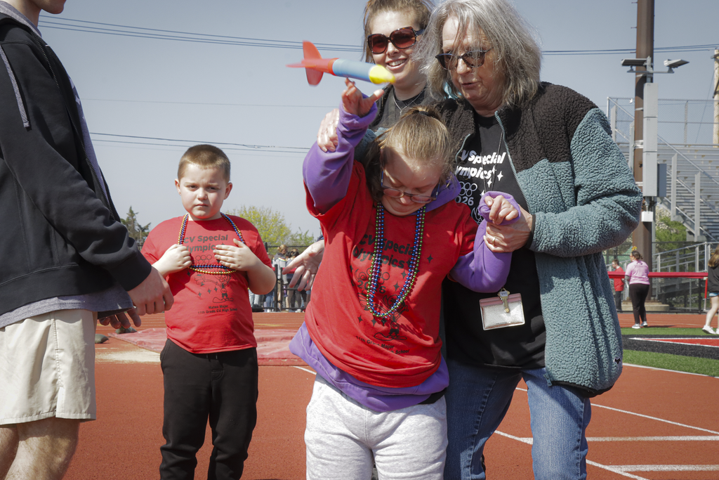 A student in a red shirt launches a rocket during CV's Special Olympics.