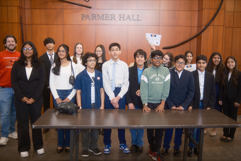 CV students stand behind a table in Parmer Hall at Messiah University, some holding certificates during National History Day Regionals.