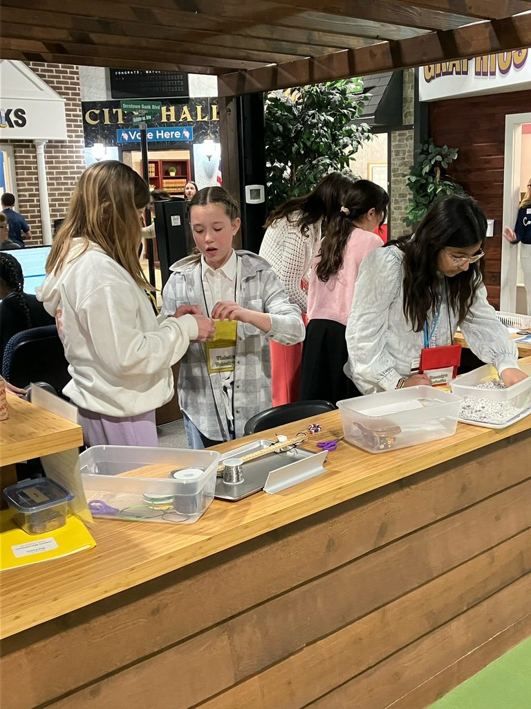 Fifth grade students work together at a small business station during a JA BizTown visit.